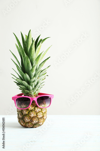 Ripe pineapple on a white wooden table