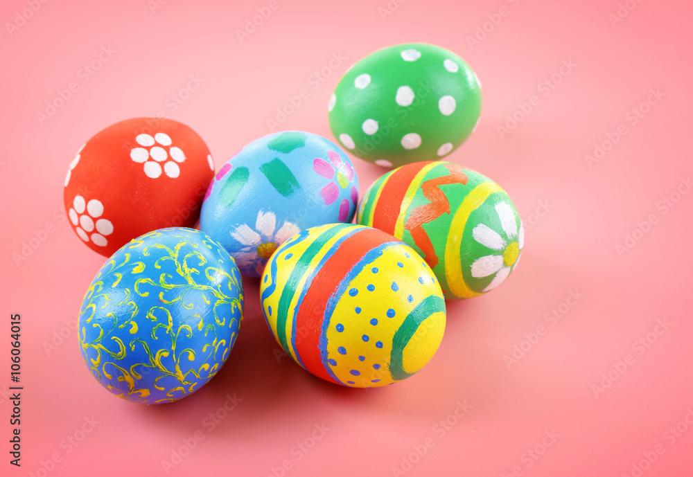 Multicoloured Easter eggs on pink background