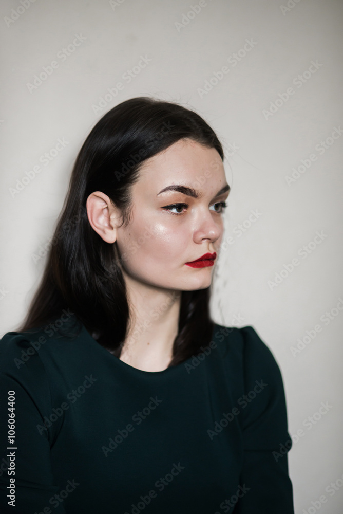 beautiful young brunette woman against a white wall beautiful young brunette woman against a white wall