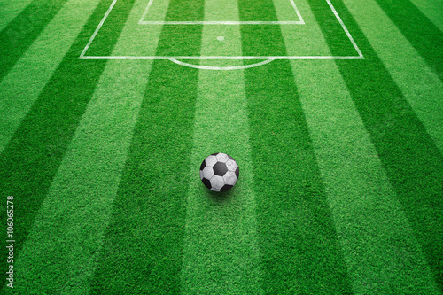 Conceptual soccer free kick ball background. Football ball on sunny soccer field ground.  © robsonphoto