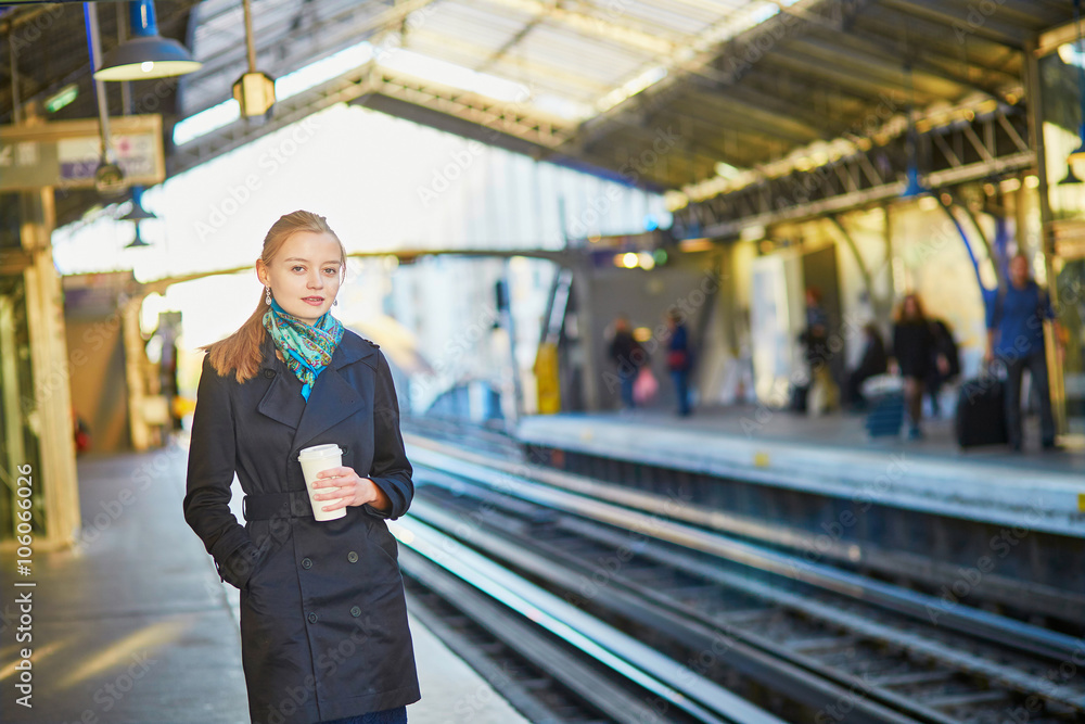 Beautiful young woman waiting for a train in Parisian undergroun Beautiful young woman waiting for a train in Parisian undergroun