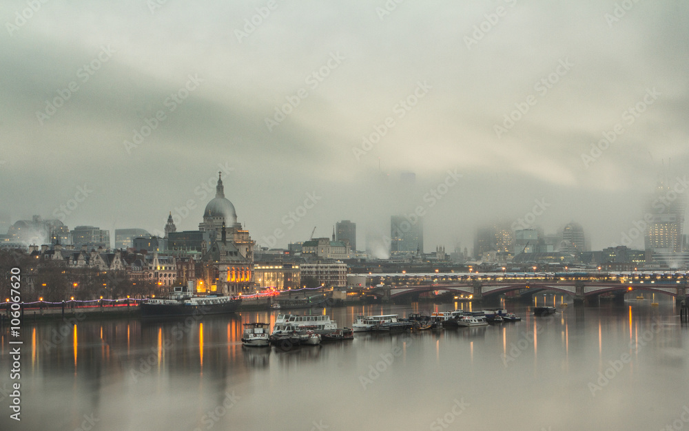 Looking eastwards over the Thames past St Paul's Cathedral and a foggy City of London