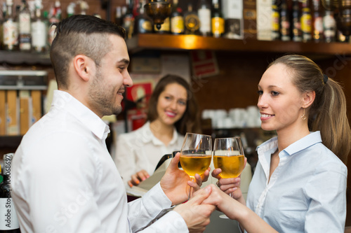 Young couple with wine at bar