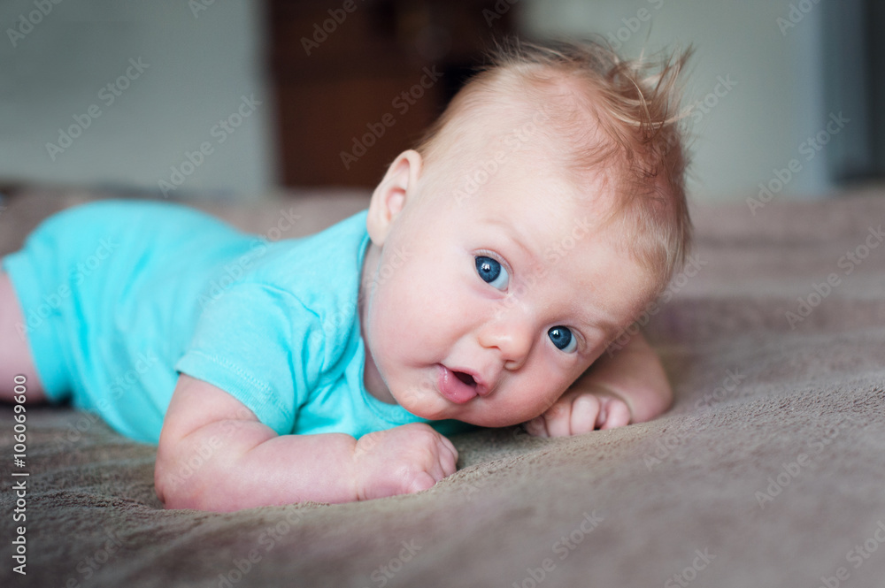 little baby boy lying on soft blanket in room little baby boy lying on soft blanket in room