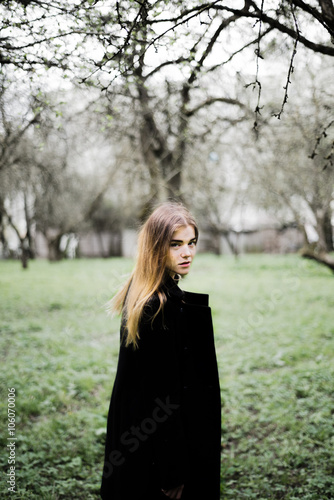 portrait of a beautiful girl in a black coat on the nature © bartashevichkara