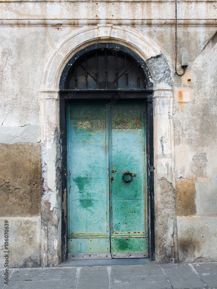 Door of an old building with rusty and peeling paint