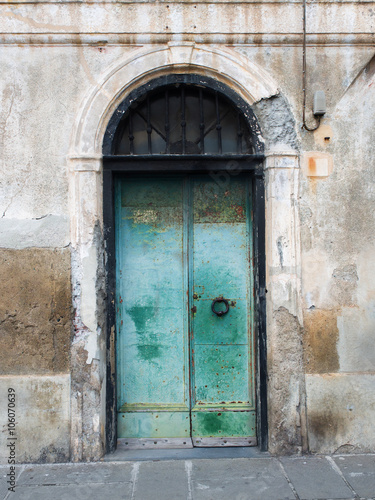 Door of an old building with rusty and peeling paint © lucag_g