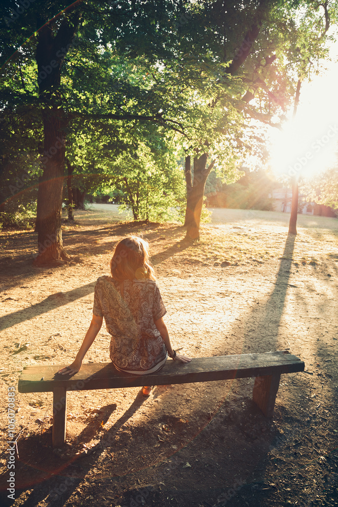 Girl sitting on a park bench