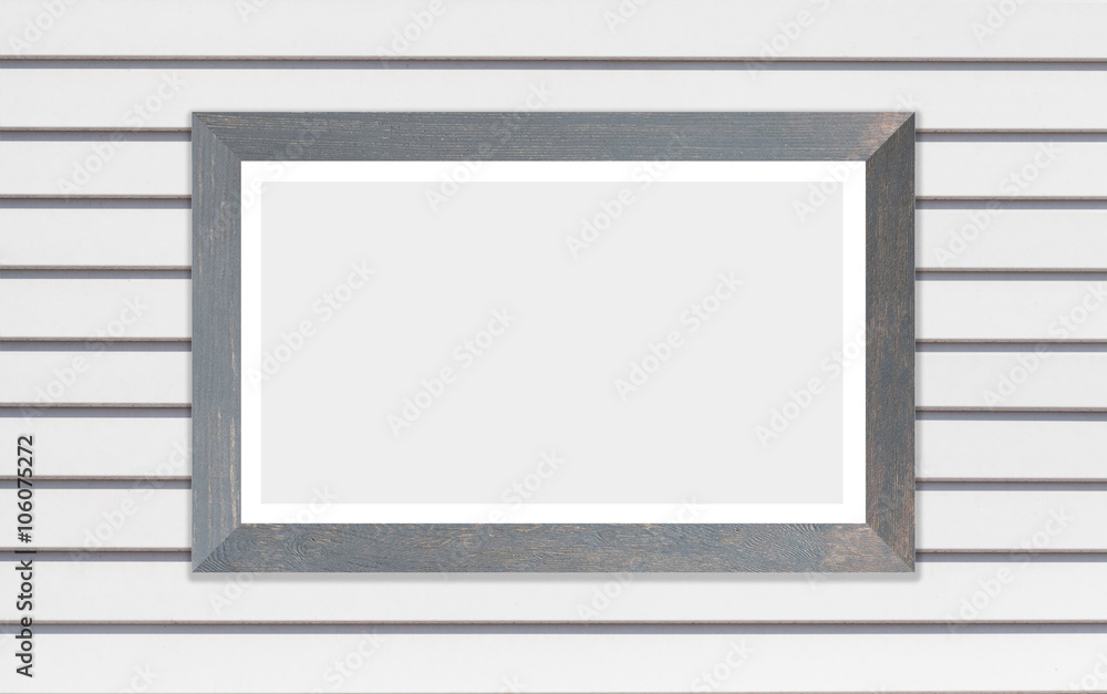 Wooden picture frame on white wood wall background Wooden picture frame on white wood wall background