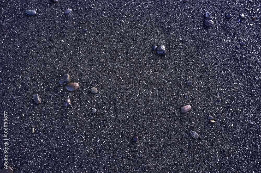 wet pebbles on black beach sand background wet pebbles on black beach sand background