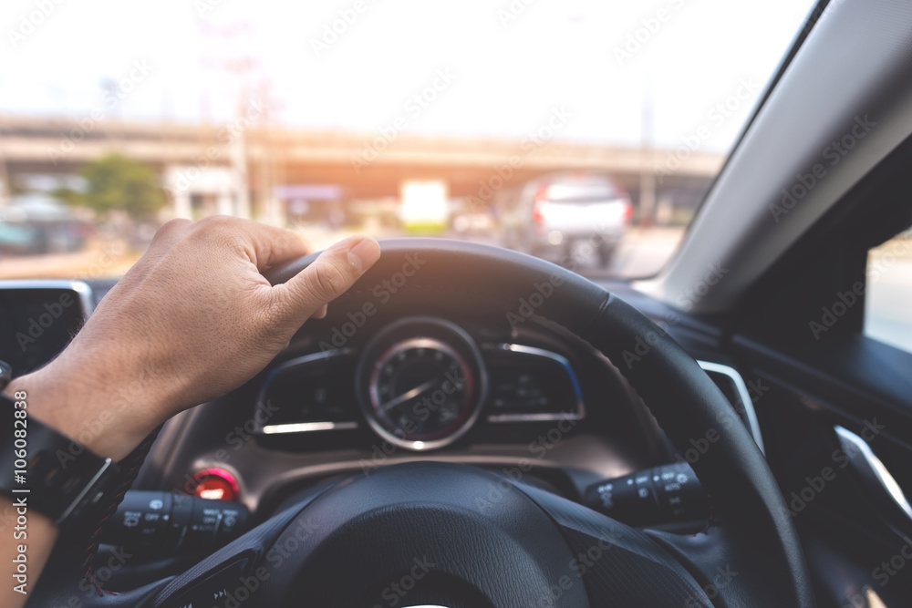 Man's hand of a driver on a modern car on the road. Vintage style processed