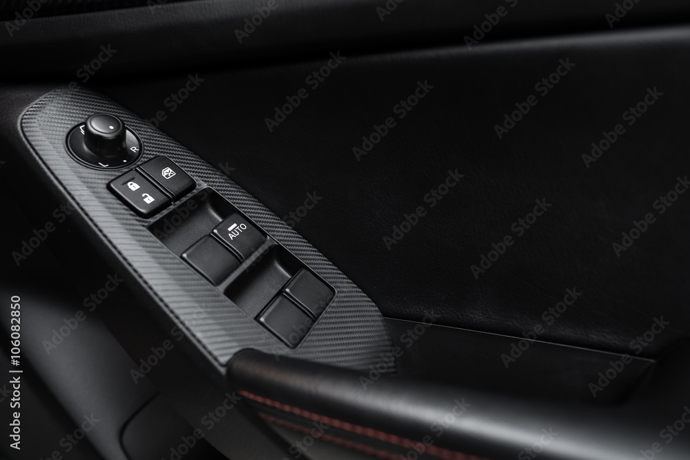 Car interior details of door handle with windows controls and adjustments. Car window controls and details Car interior details of door handle with windows controls and adjustments. Car window controls and details