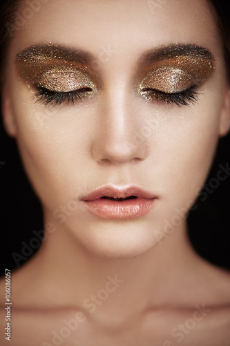 Beautiful woman face. Perfect makeup. Beauty fashion. Eyelashes. Lips. Cosmetic Eyeshadow. Make-up detail. Eyeliner