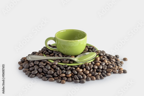 coffee beans and green cup isolated on a white background