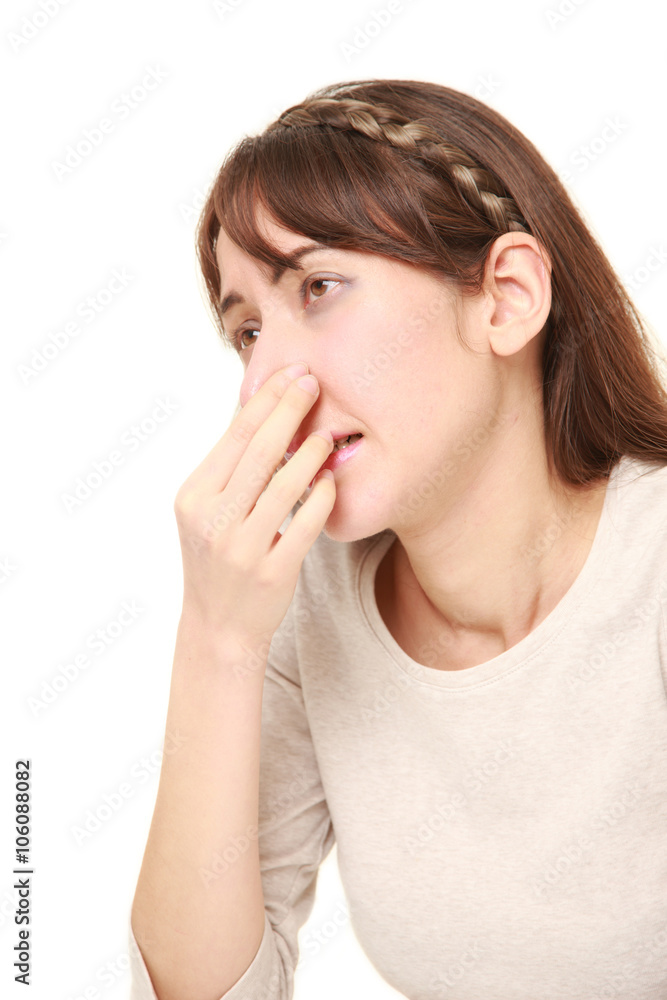 woman holding her nose because of a bad smell woman holding her nose because of a bad smell