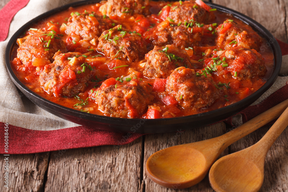 Tasty meatballs with spicy tomato sauce on a dish close-up. horizontal
