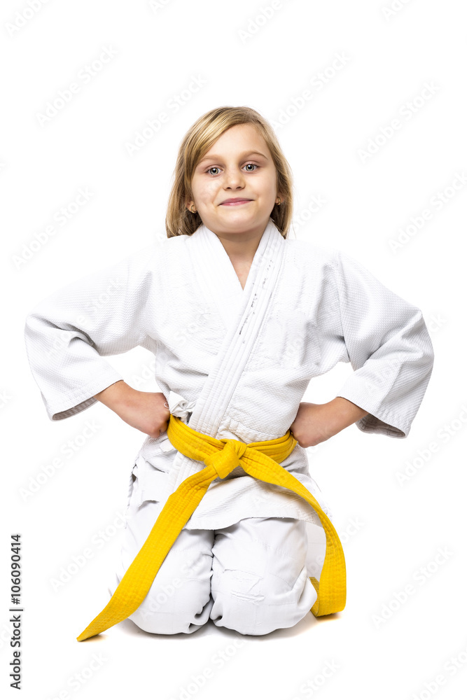 Pretty little girl in white kimono down on knees ready to fight