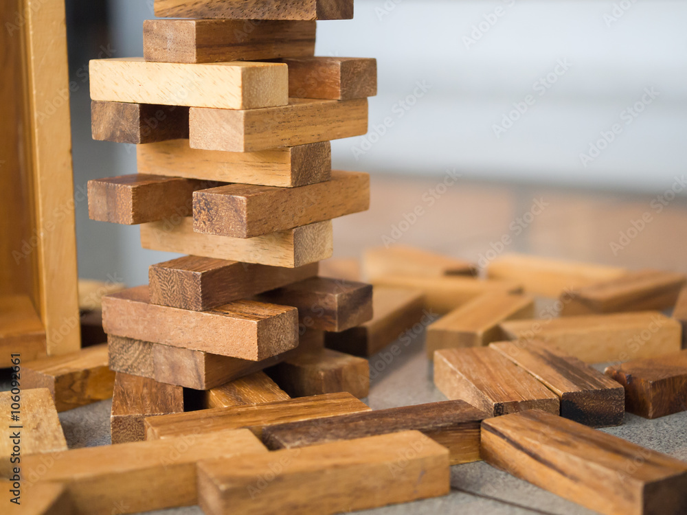 Closeup of asian kid's hand playing wood blocks stack game (jeng Closeup of asian kid's hand playing wood blocks stack game (jeng