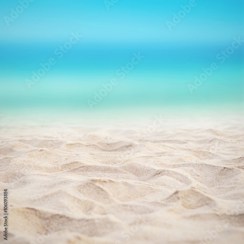 Close up sand with blurred sea sky background, summer day, copy space.