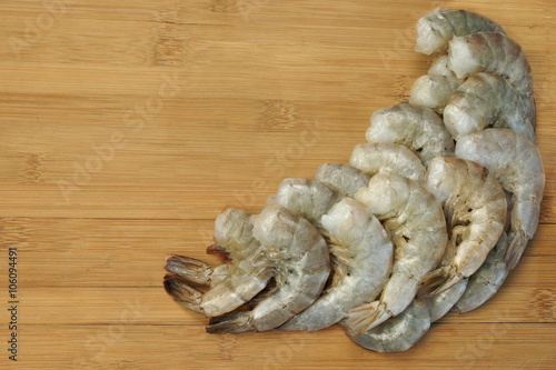 Many Raw Green King Size Shrimps On Wooden Background