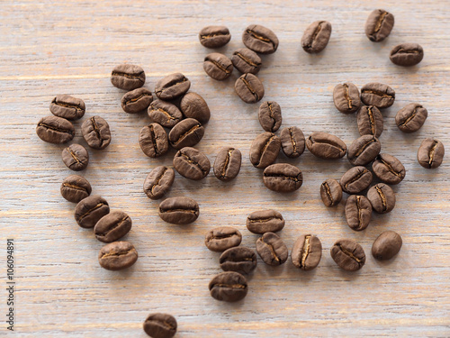 Roasted coffee crop on wooden, background texture