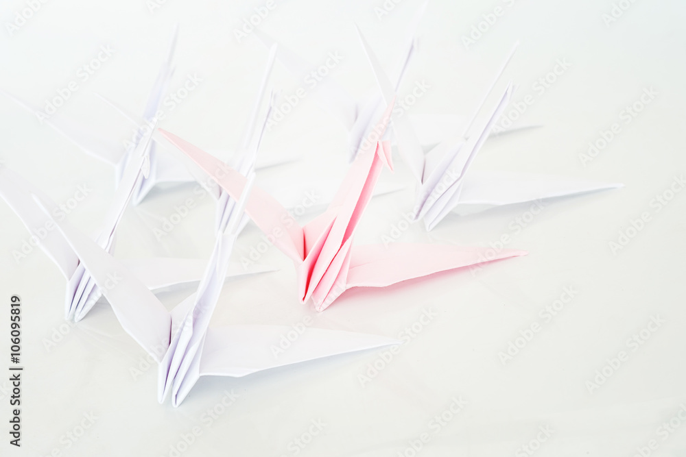 Naklejka premium Leadership concept with pink paper bird leading among white