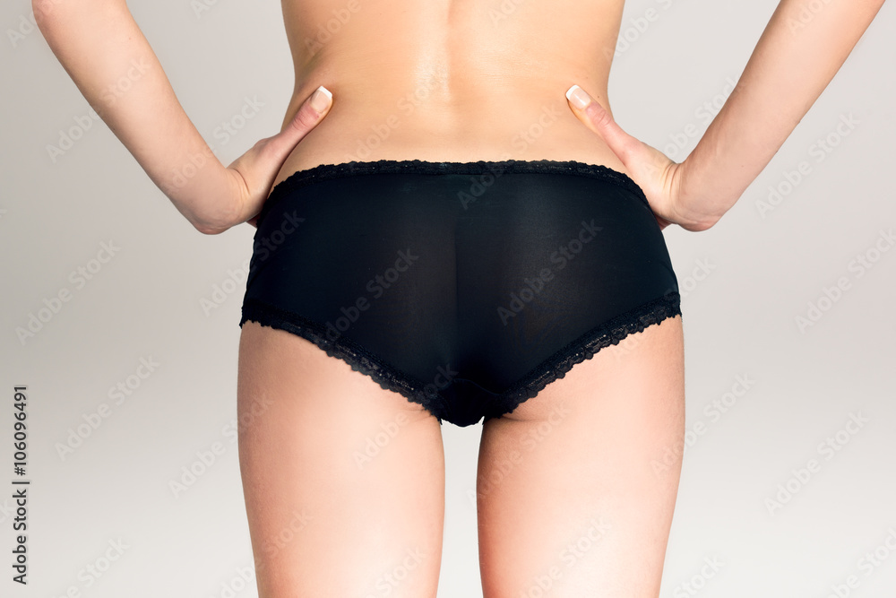 Fotografia do Stock: Female ass wearing black panties against