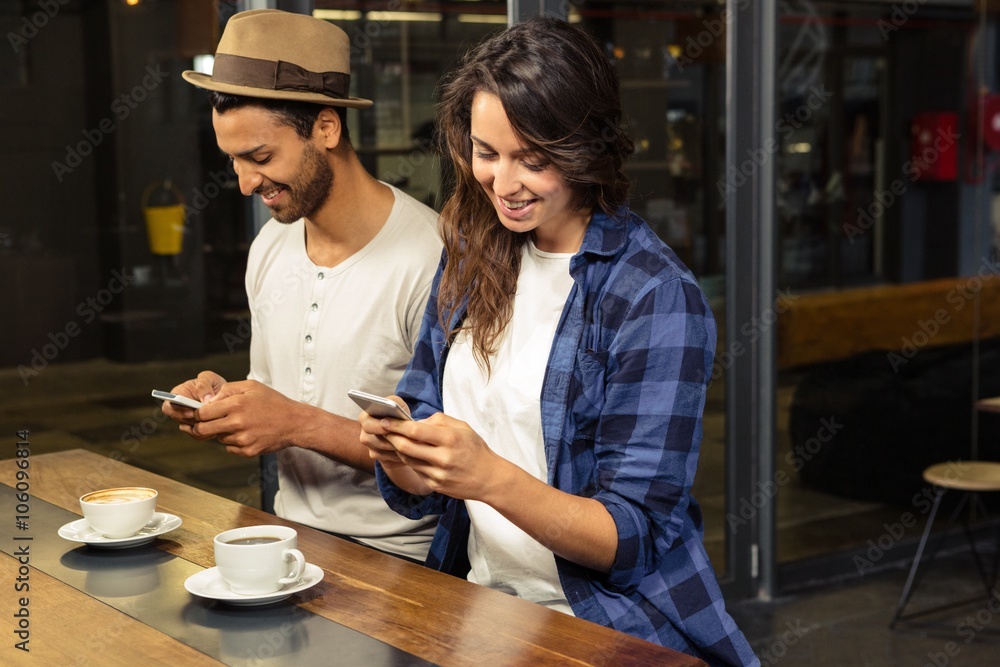 Couple using smartphones Couple using smartphones