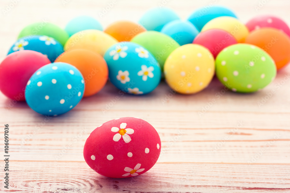 Easter eggs. Colorful Easter eggs on white wooden desk selective focus. Top view, horizontal. Easter eggs. Colorful Easter eggs on white wooden desk selective focus. Top view, horizontal.