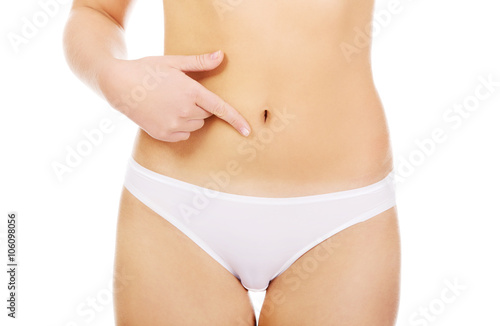 Woman pointing finger for her belly 
