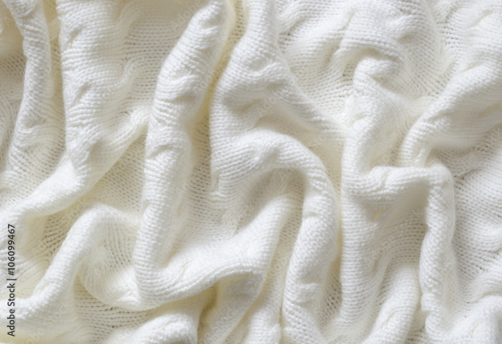 Fototapeta premium Crumpled white knitted blanket