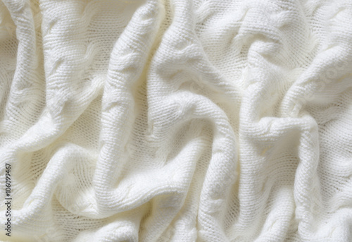 Crumpled white knitted blanket