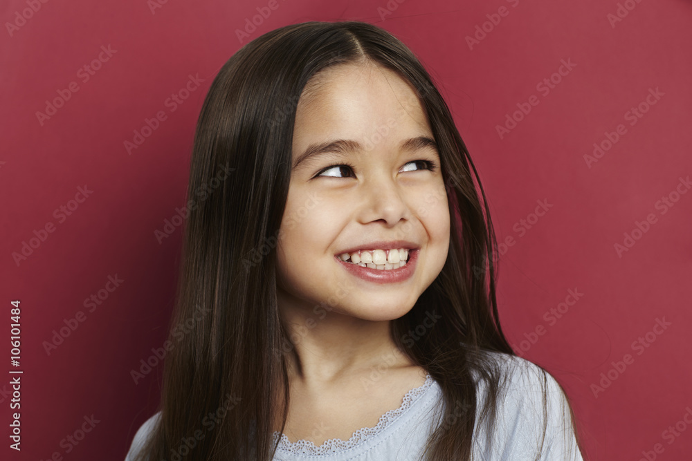 Smiling girl on red, looking away Smiling girl on red, looking away