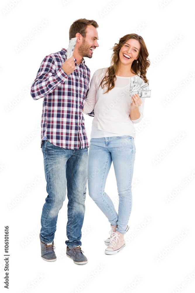 Happy young couple holding fanned out currency notes Happy young couple holding fanned out currency notes