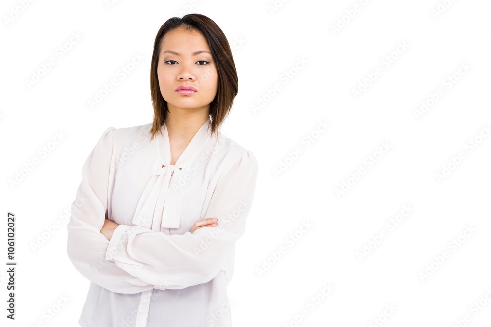 Angry young woman standing with arms crossed Angry young woman standing with arms crossed