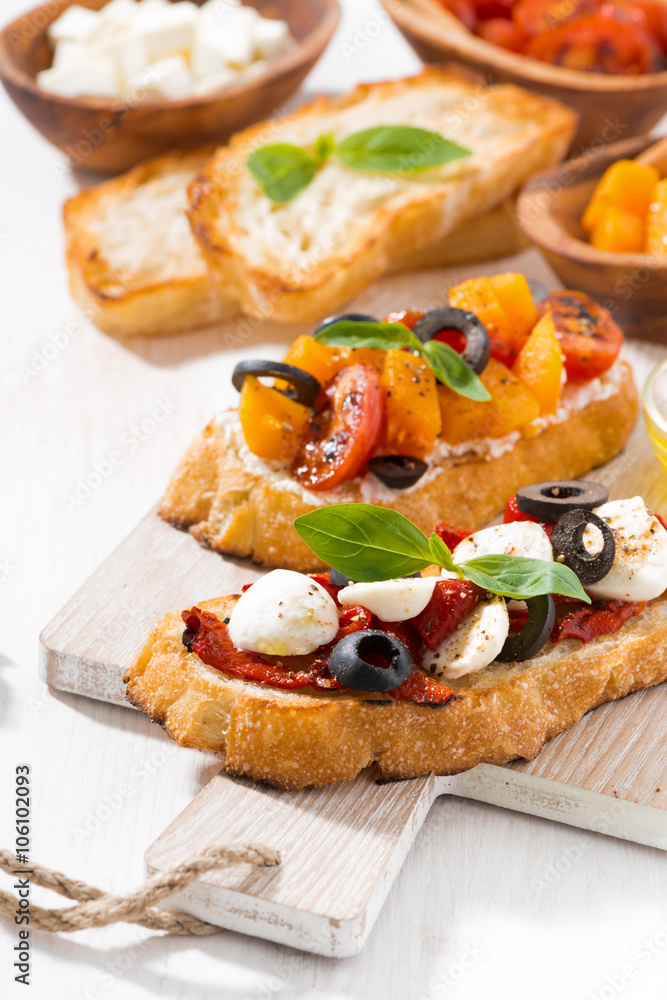 bruschettas with tomatoes and mozzarella on wooden board