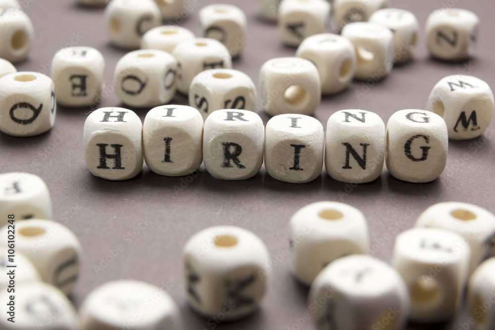 HIRING word written on wood block. Wooden Abc HIRING word written on wood block. Wooden Abc