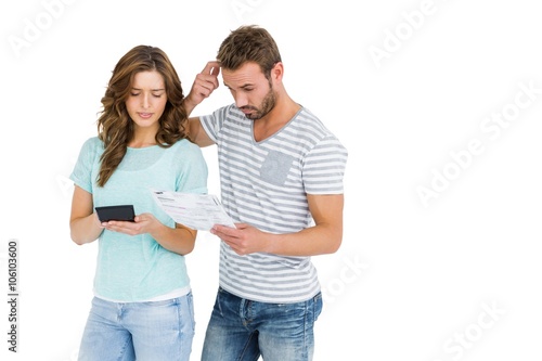 Worried couple calculating bill on calculator © WavebreakmediaMicro
