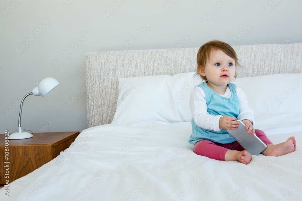 adorable baby sitting on a bed adorable baby sitting on a bed