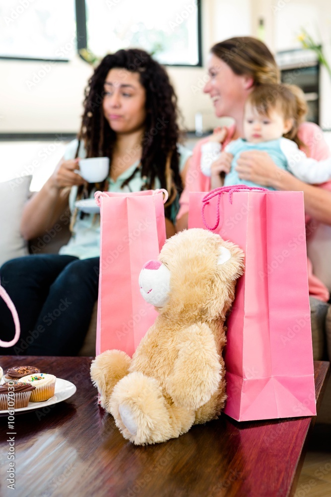 Two women and a baby surrounded by gifts Two women and a baby surrounded by gifts