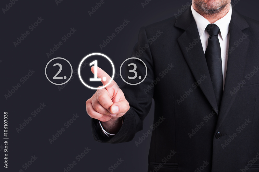 Businessman choosing number one digital button from touchscreen Businessman choosing number one digital button from touchscreen