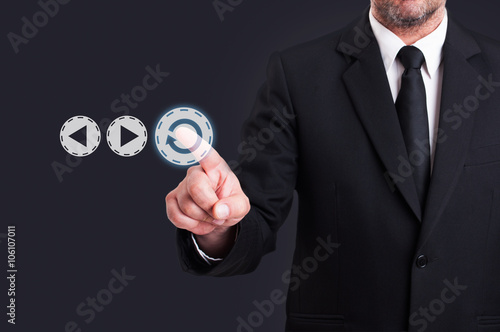 Businessman hand press replay digital button photo