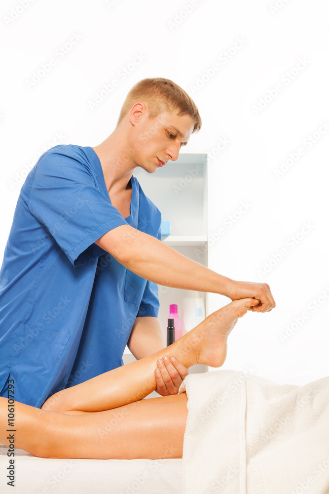 Obraz premium Masseur making feet massage in spa salon