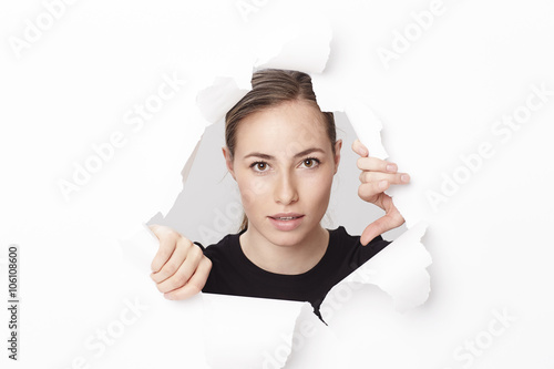 Beautiful woman emerging from paper, portrait