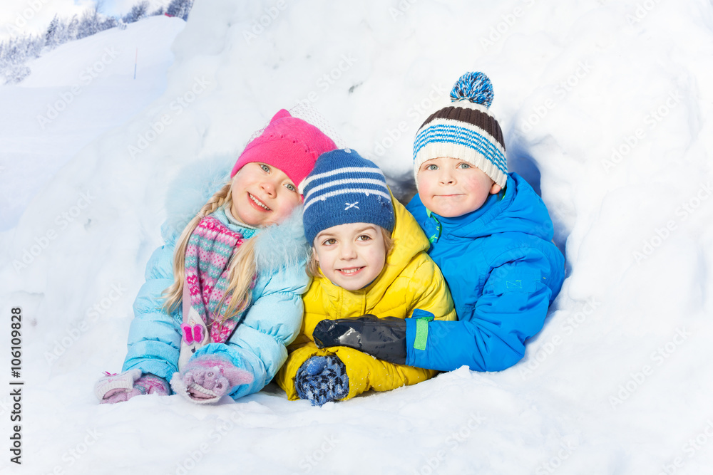 Group of little kids play in snow igloo
