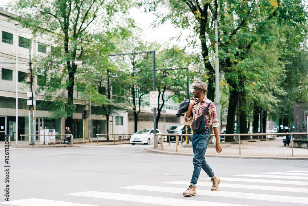 custom made wallpaper toronto digitalYoung handsome afro man walking outdoor in the city holding a ba