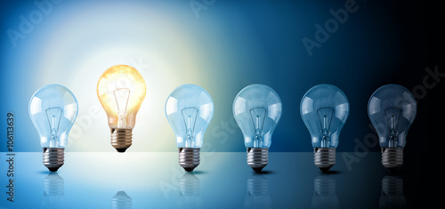 Idea concept with light bulbs sequence on blue background