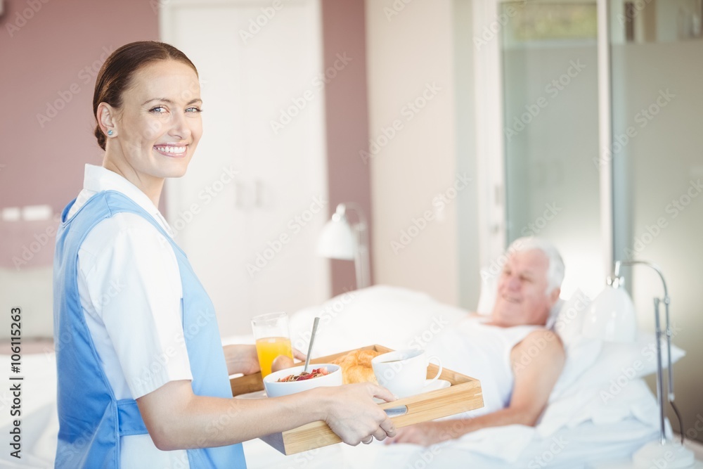 Portrait of confident nurse with tray Portrait of confident nurse with tray