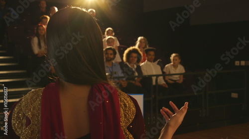 Wallpaper Mural Over the shoulder view of a teenage girl giving a presentation to a group of students and teachers in her school. Torontodigital.ca