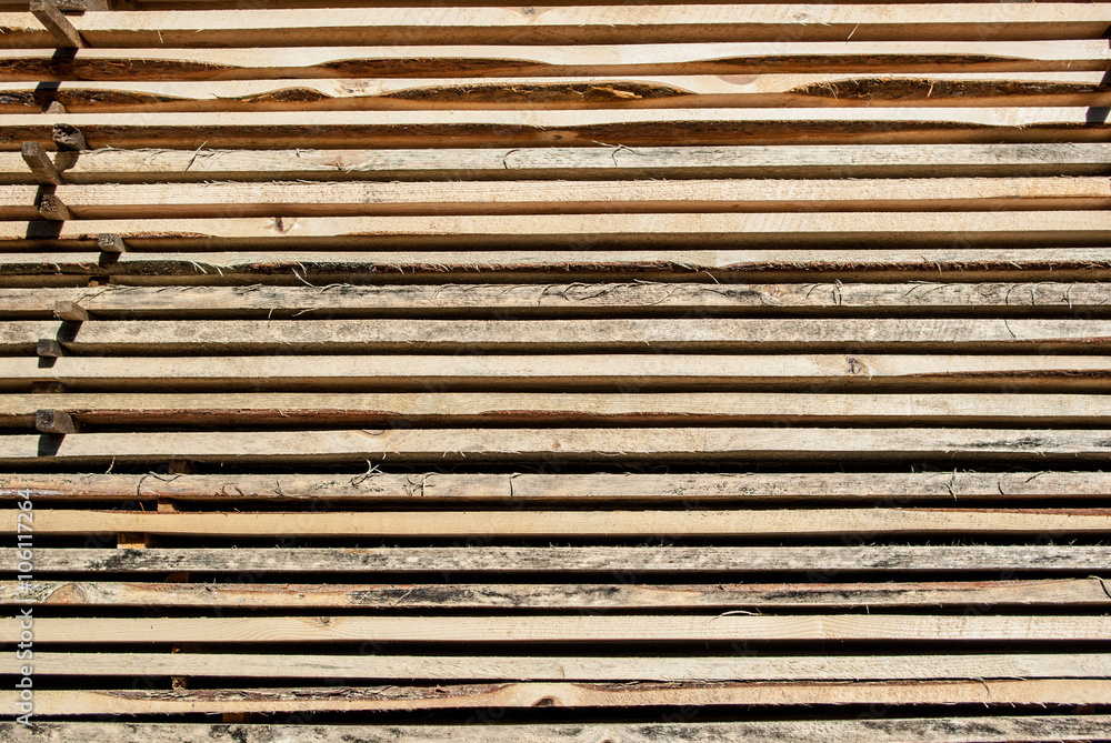 Fresh wooden boards stacked to the warehouse. Wood background Fresh wooden boards stacked to the warehouse. Wood background